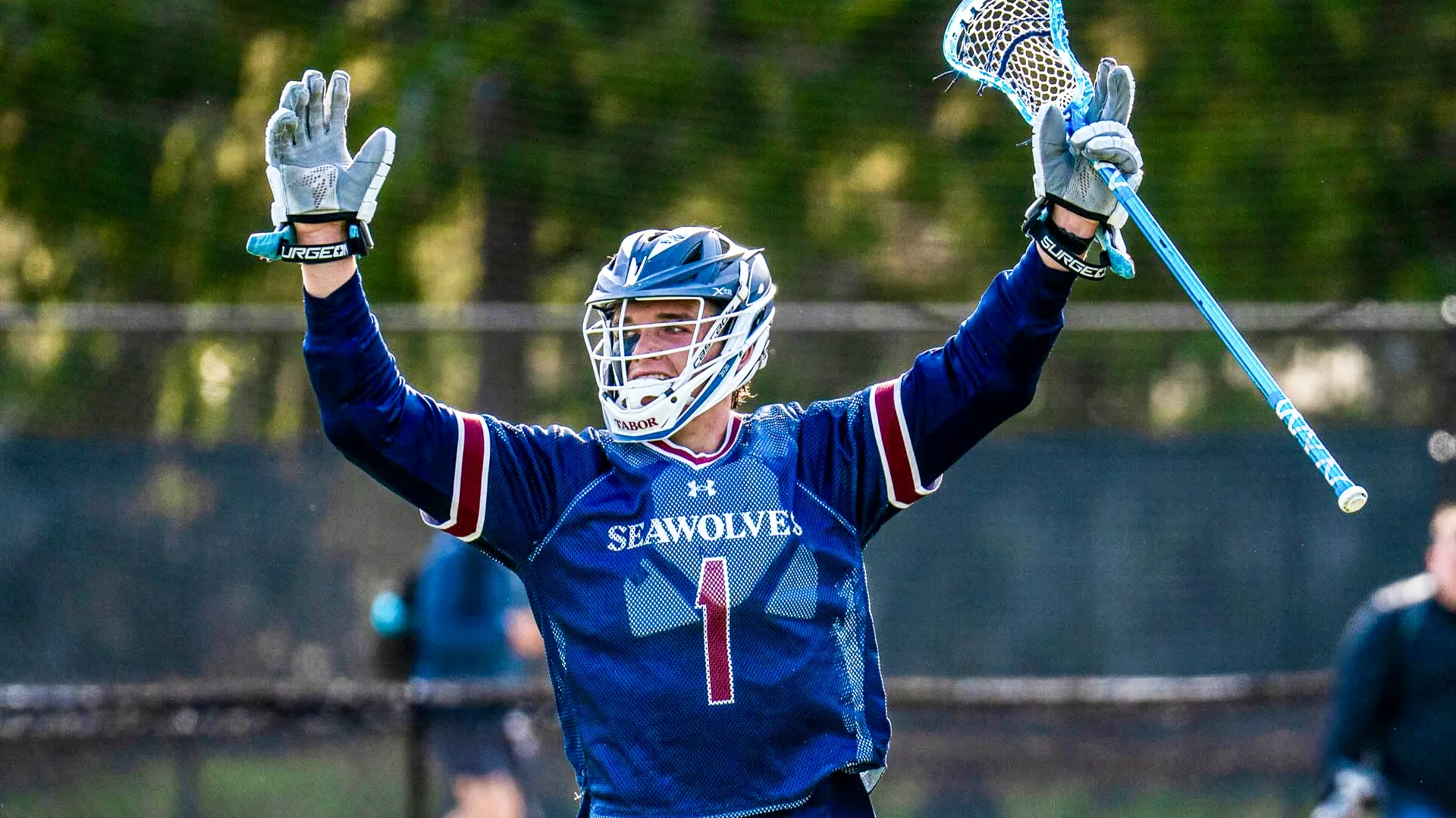 Landen O'Neil celebrates after scoring a goal for Tabor (Mass.) in ISL play