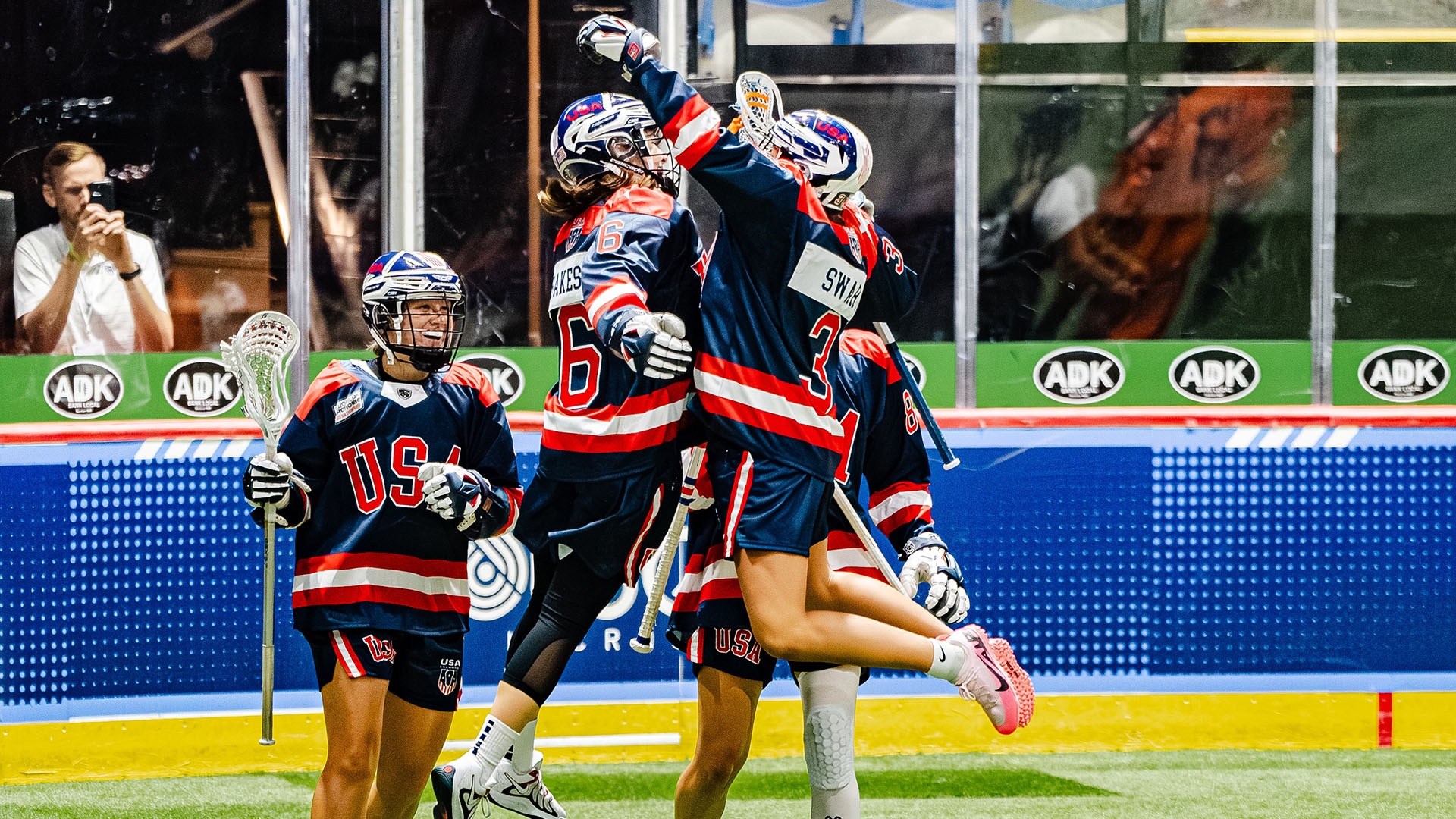 USA women's box lacrosse team celebrates a goal