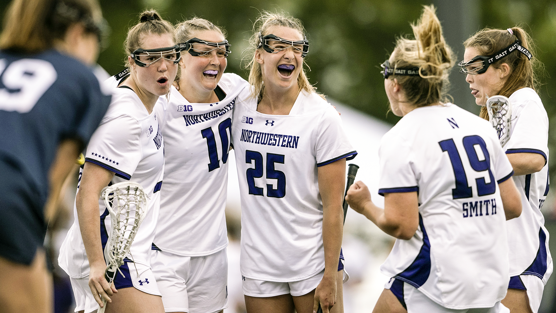 Madison Taylor surrounded by Northwestern teammates celebrating her goal in the 2024 Big Ten women's lacrosse championship