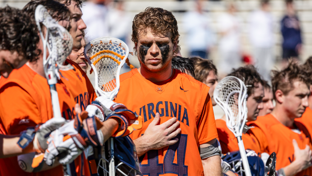 Virginia lacrosse player Ben Wayer holds his hand over his heart during the national anthem before a game against Maryland