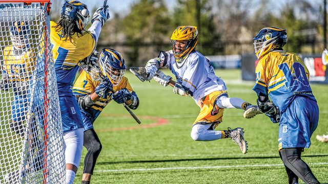 Bowie State’s Jared Morgan Jr. takes to the air to shoot past Coppin State goalie Jason Bandoh in a Next Collegiate League game at USA Lacrosse’s Tierney Field in Sparks, Md. 