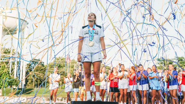 Sam Apuzzo surrounded by confetti as she stands on the champion's pedestal following the Athletes Unlimited season finale at USA Lacrosse in Sparks, Md. 