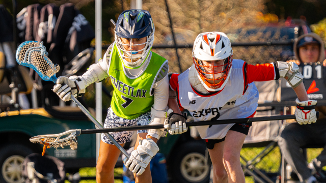 Players from SweetLax and Express Lacrosse set up on the faceoff wing.