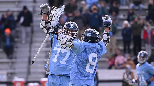 Dom Pietramala and Owen Duffy raise their arms after a North Carolina goal