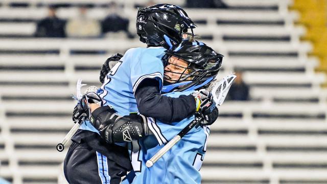 Johns Hopkins players celebrating a goal during the Blue Jays' 11-10 win at Towson on Tuesday