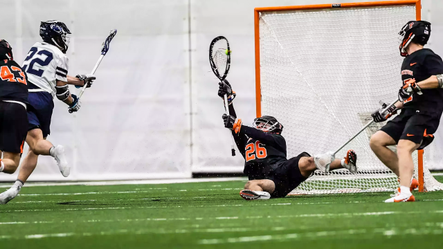 Princeton goalie Ryan Croddick makes a diving stop of a Penn State shooter at Holuba Hall.