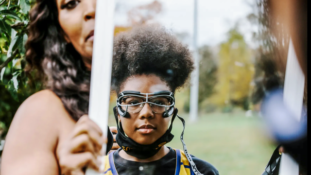 Eyekonz founder holds a mirror in front of lacrosse player Erin Mobley