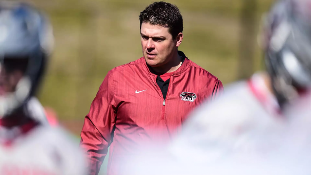 Saint Joseph's coach Taylor Wray observing in background with players in foreground