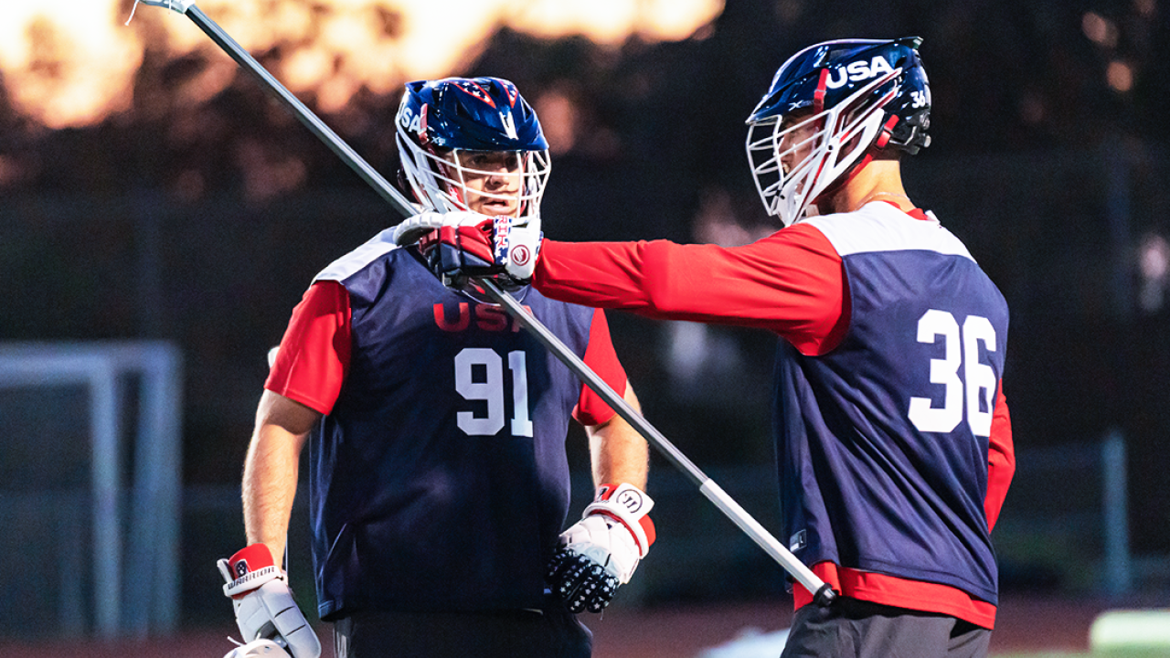 Defenseman Jesse Bernhardt (36) and goalie Jack Kelly (91) confer during a U.S. national team practice Tuesday at Canyon Hills High School in San Diego.