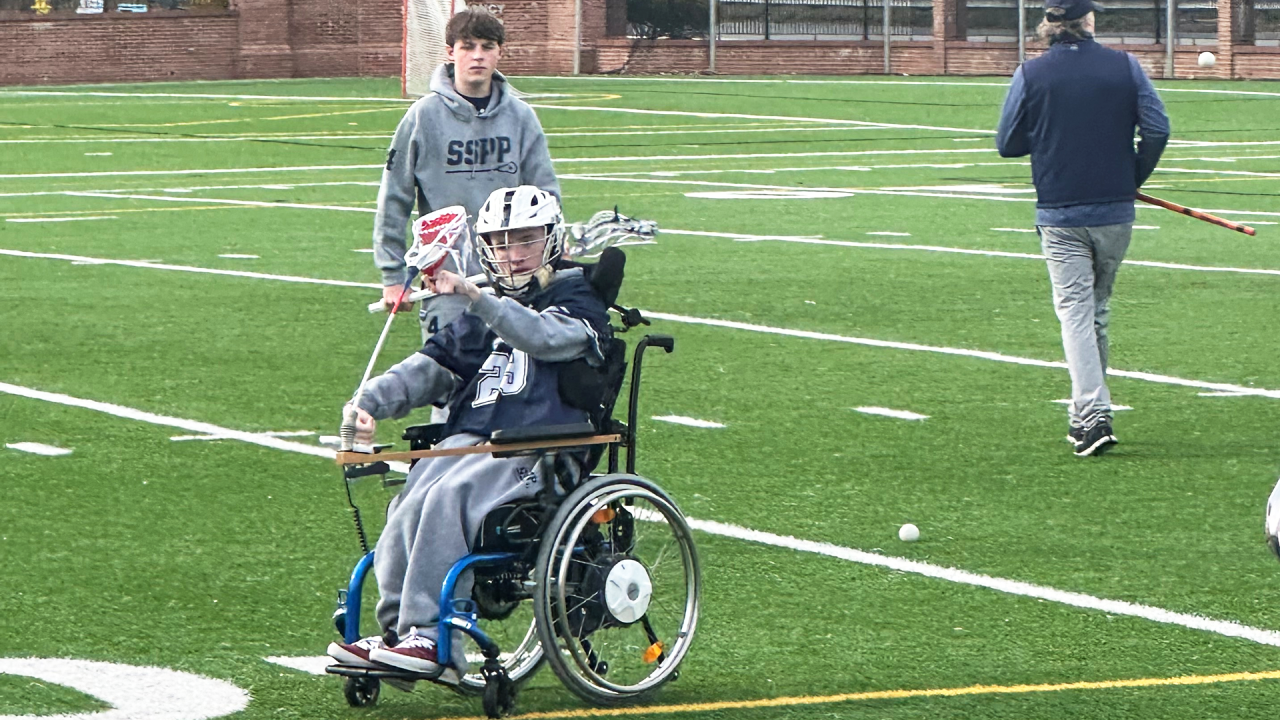 Caleb Krewson of Saints Peter & Paul on the field with his favorite wheelchair accessory — a lacrosse stick