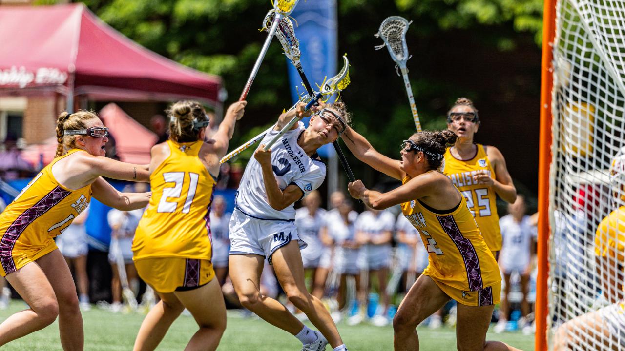 Middlebury women’s lacrosse player Hope Shue shoots over and through a sea of Salisbury defenders.