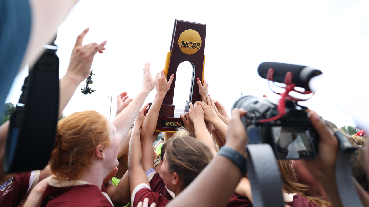 Boston College players hold up the NCAA championship trophy following their comeback victory against Northwestern at WakeMed Soccer Park in Cary, N.C.