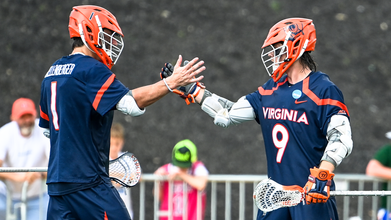 Virginia lacrosse players Connor Shellenberger (1) and McCabe Millon (9) slap hands during the NCAA quarterfinals at Towson.