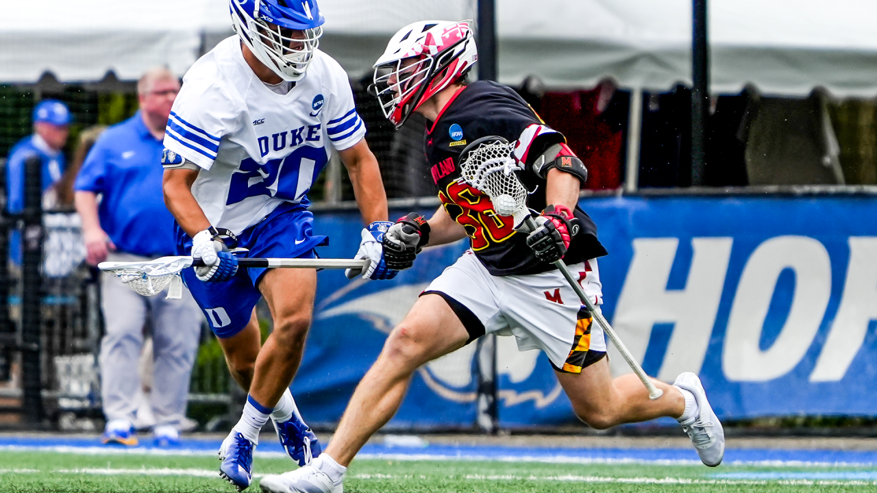 Maryland midfielder Ryan Siracusa (38) carries the ball against a Duke defender in the NCAA quarterfinals at Hofstra