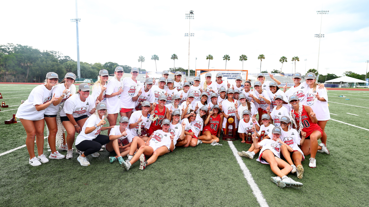 Tampa team photo with the NCAA championship trophy, the Spartans' first Division II women's title.