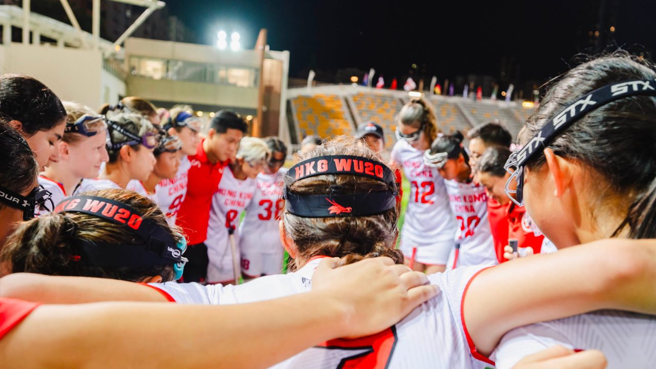 Host Hong Kong huddles before its World Lacrosse Women's U20 Championship opener at Mong Kok Stadium.