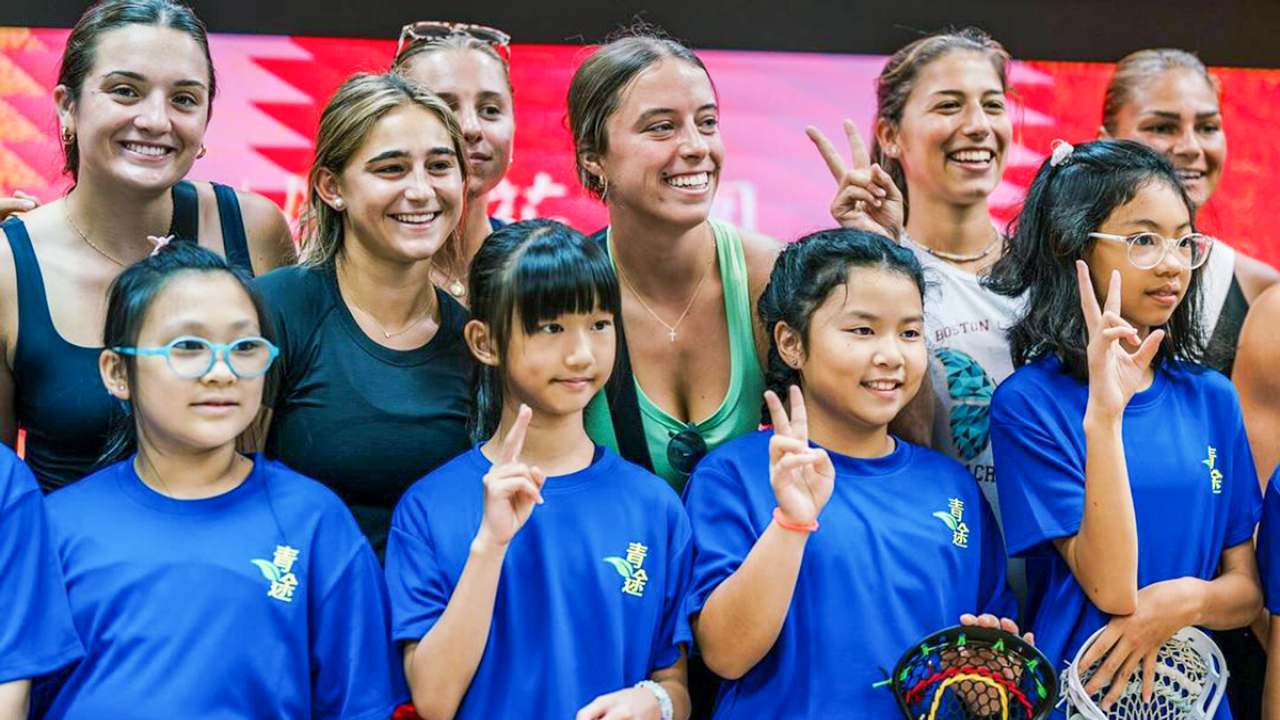 U.S. Women's U20 National Team members with students from the Shamshuipo Kaifong Welfare Association Primary School