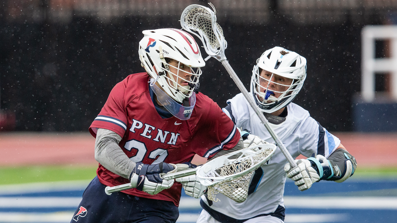 Penn goalie Emmet Carroll runs upfield with the ball as a Villanova player gives chase 