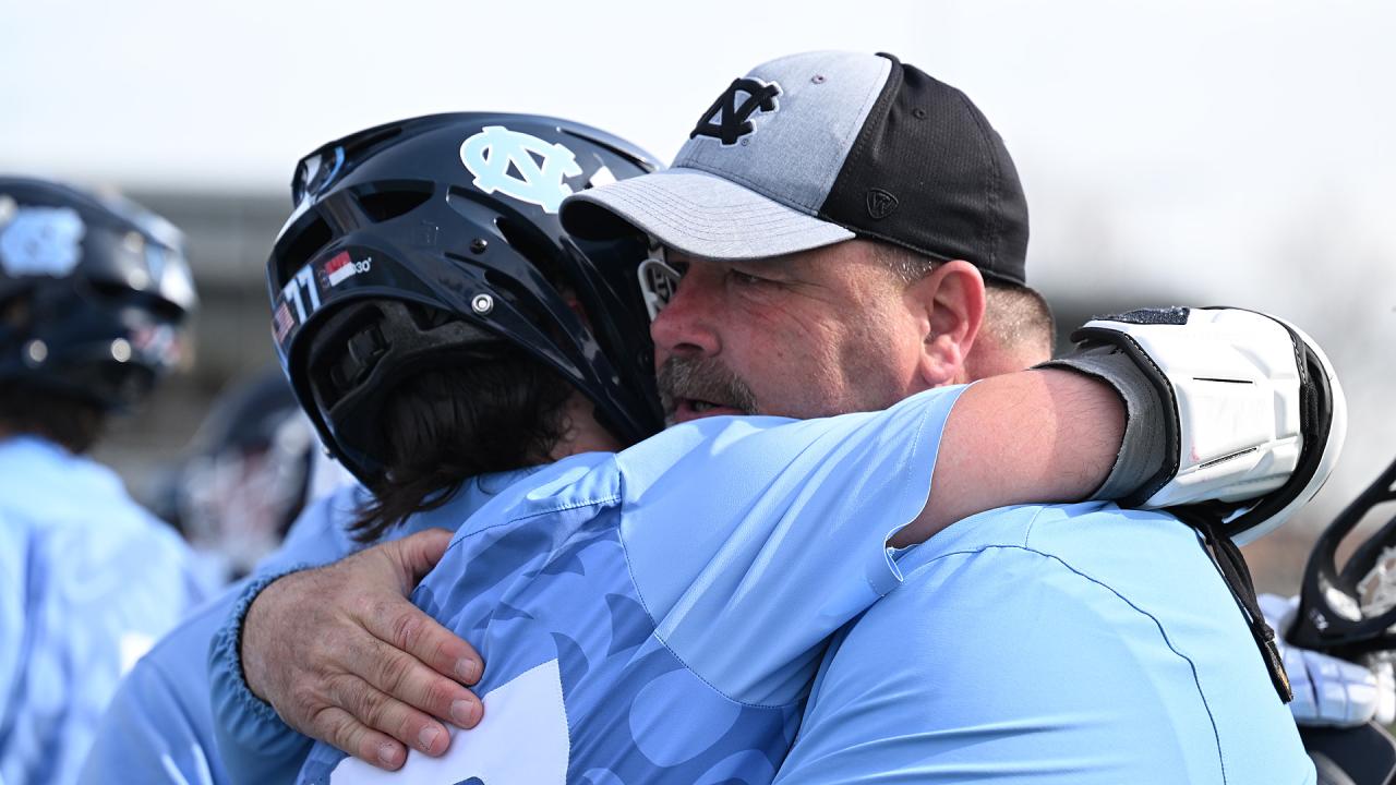 Dom Pietramala hugs his father, Dave Pietramala, after North Carolina's victory over Johns Hopkins.