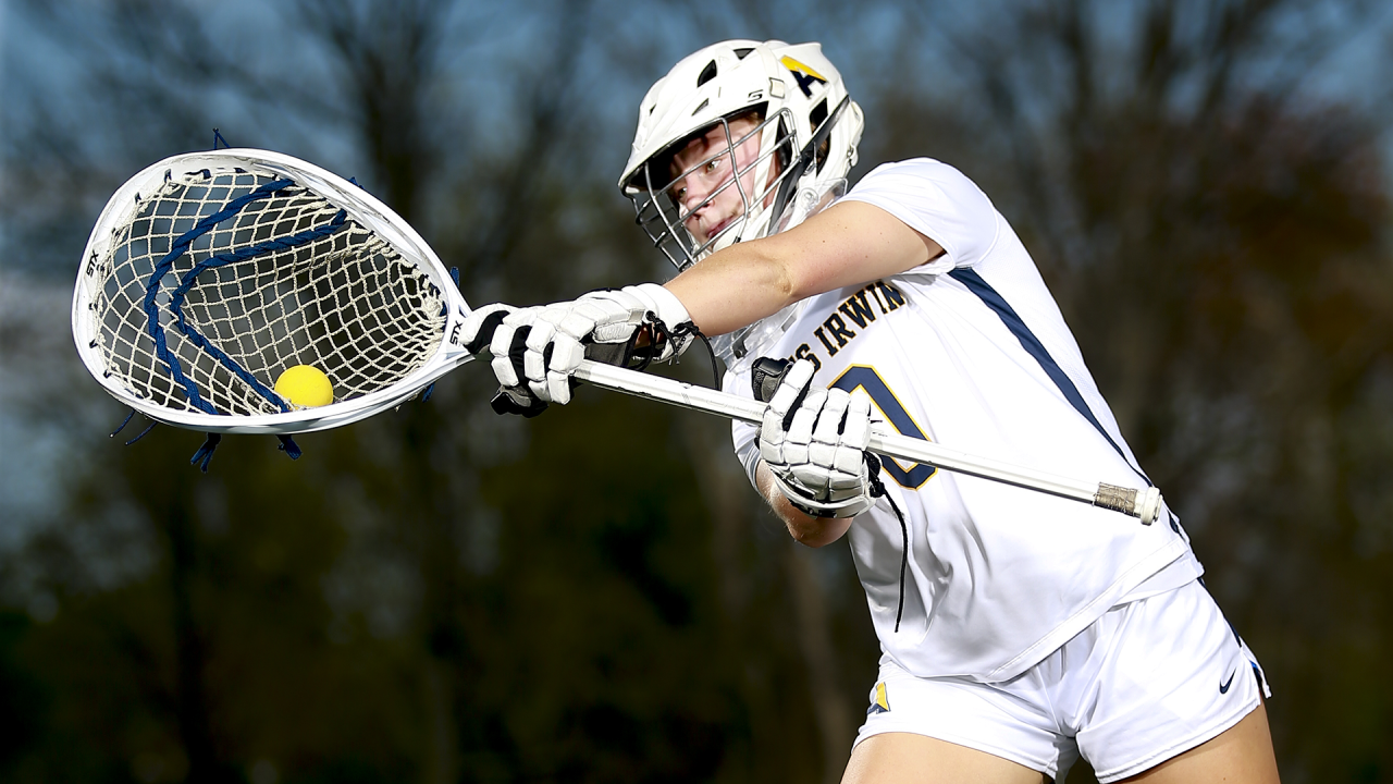 Agnes Irwin (Pa.) goalie Rowan Pauzano ranging to her right to make an overhand save