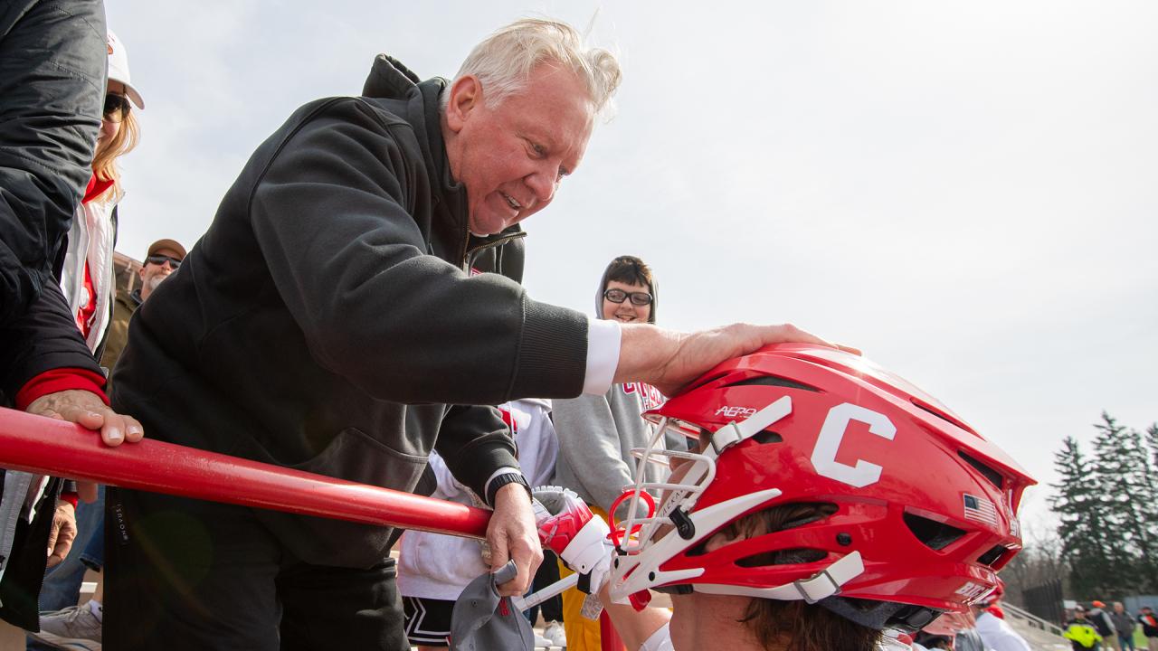 Mike French congratulates C.J. Kirst after Kirst broke French's career goals mark at Cornell.