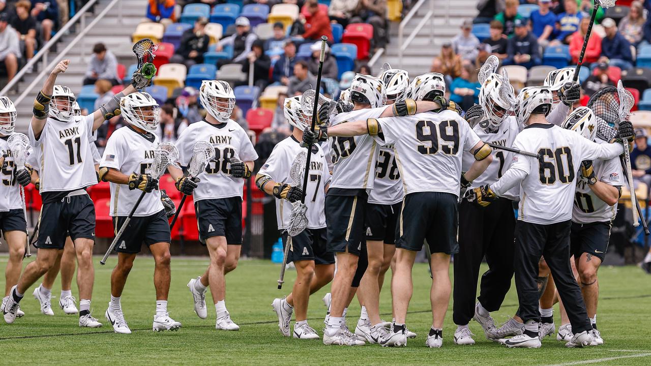 Army men's lacrosse players congregate on the field during a 2024 game in Atlanta